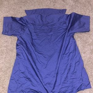 Man’s short sleeve blue shirt. Size medium, flash is on to see texture of shirt.